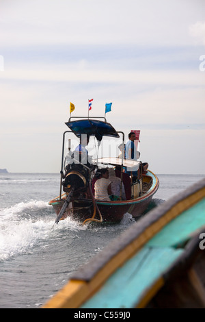 Detail of local people on long tail boat in Andaman Sea, Phi Phi Island, Thailand. Stock Photo