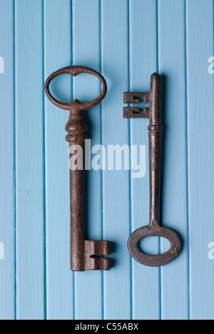 Two old keys in opposite direction Stock Photo