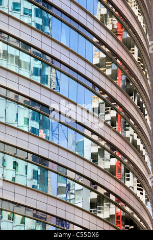Modern round office building abstract architecture, reflections on windows. Stock Photo