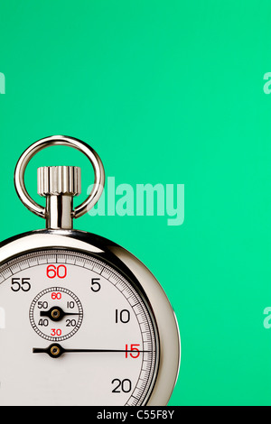 Stopwatch against green background Stock Photo