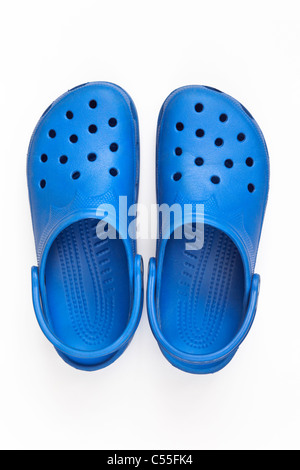 Top down of a pair of blue Crocs plastic sandal shoes cut out and isolated on a white background from above. Stock Photo