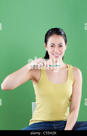 Young woman brushing teeth Stock Photo
