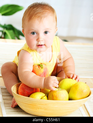 Little baby choosing fruits, closeup portrait, concept of health care & healthy child nutrition Stock Photo