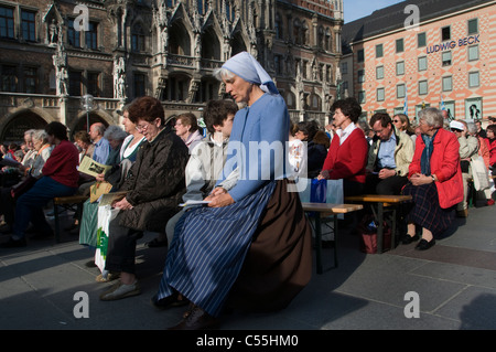 Germans attending a catholic mass outdoor in front of Marienplatz, town hall in the city of Munich capital of Bavaria Germany Stock Photo