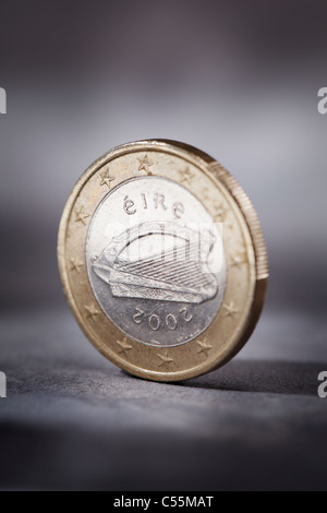 A Worn Irish Euro coin on grey. Short depth of field. Stock Photo