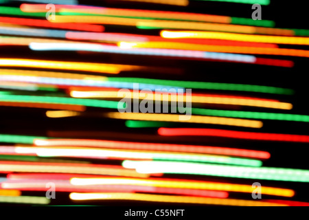 Multicolored streaks of light against a black background Stock Photo