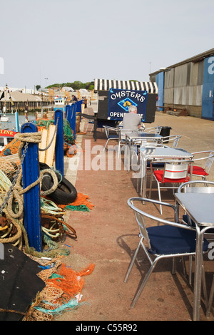 An Oyster-cart and 'Fish Market' tables in Whitstable harbour, Kent, England, UK Stock Photo