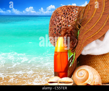 Beach items over blue sea conceptual image of summertime vacation & holidays Stock Photo