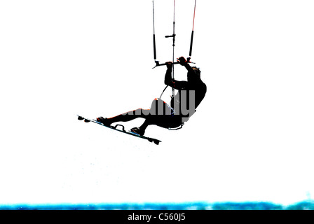 Kite surfer in action jumping, silhouetted Stock Photo