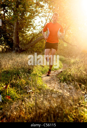 Man running at sunset in a park, San Clemente Canyon, San Diego County, California, USA Stock Photo