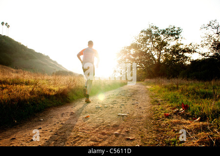 Man running at sunset in a park, San Clemente Canyon, San Diego County, California, USA Stock Photo