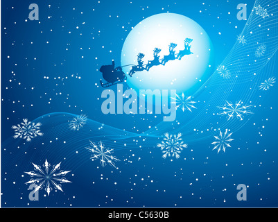 Silhouette of santa flying through a night sky Stock Photo