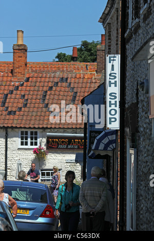 People wandering along the high street, in the village of Blakeney. Stock Photo