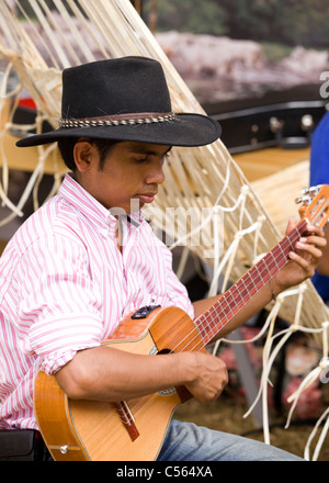 A young indigenous Colombian man plays guitar Stock Photo