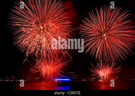 Red fireworks explode during the annual Macy's show on the  Hudson River in New York City July 4th 2011. © Craig M. Eisenberg Stock Photo