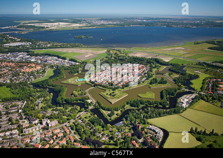 The Netherlands, Naarden, Star shaped fortressed village with canals, ramparts, bastions and ravelins. Aerial. Stock Photo