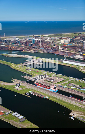 The Netherlands, IJmuiden, Aerial view of entrance and locks of North Sea Canal. Background Tata steel factory. Stock Photo