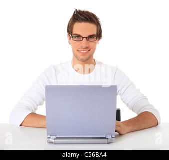 Smiling young guy using notebook computer. All on white background. Stock Photo