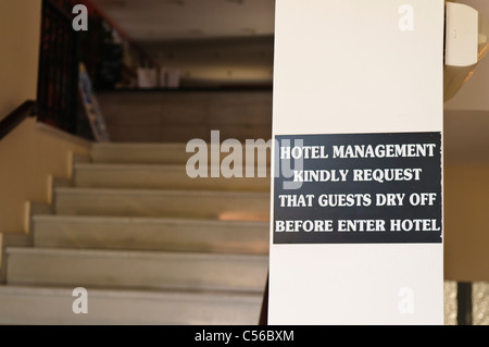 Sign at a hotel asking guests to ensure they dry themselves before entering the hotel Stock Photo