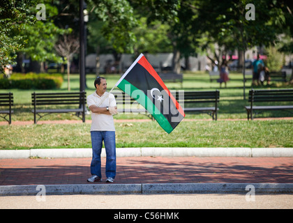 A man holding a Libyan Republic flag Stock Photo