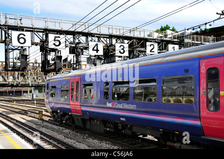 First Great Western train below Royal Oak signal gantry with very large numbers on approach to Paddington station London England UK Stock Photo