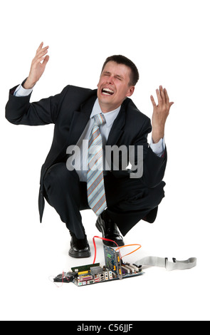 businessman is crying over the broken computer on a white background Stock Photo