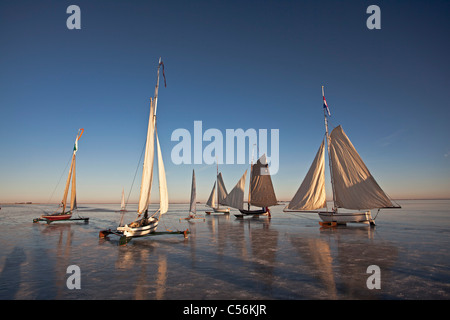 The Netherlands, Monnickendam. Ice sailing boats on frozen lake called Gouwzee. Stock Photo