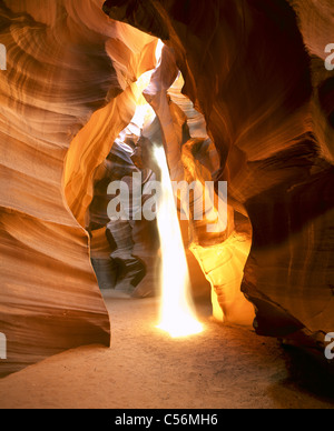 In the summer, rays of sunlight create ghostly appearances in this dusty slot canyon. Upper Antelope Canyon, Coconino County, Arizona, USA. Stock Photo