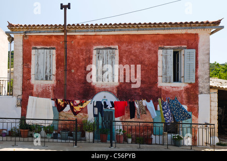 House in a small Greek mountain village with laundry hanging out to dry Stock Photo