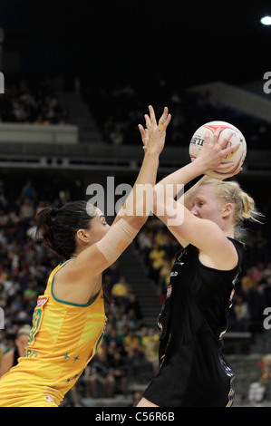 10.07.2011 Mo'onia Gerrard of Australia(left) attempts to close down Laura Langman during the Finals between Australia and New Zealand, Mission Foods World Netball Championships 2011 from the Singapore Indoor Stadium in Singapore. Stock Photo