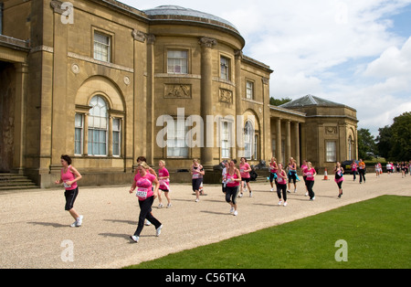 Race for LIfe, women only, 5k cancer charity event runners pass in front of Heaton Hall, Heaton Park, Manchester, UK Stock Photo