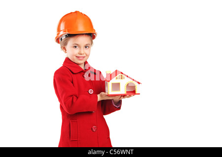 A child with helmet holding a model house Stock Photo