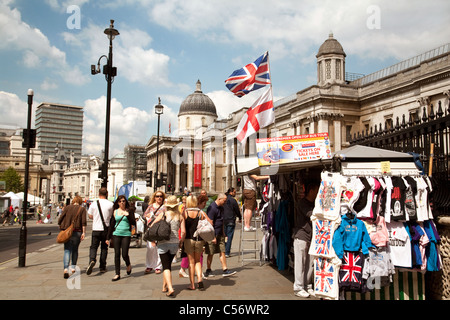 People walking past tourist souvenir stalls, Trafalgar Square, london UK Stock Photo