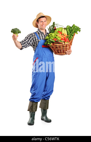 Full length portrait of a male farmer holding a basket full of vegetables Stock Photo