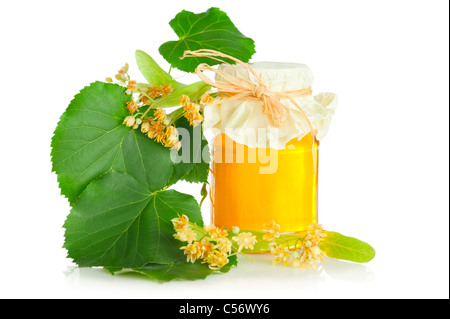 Fresh sweet honey and branch with flowers of linden tree on white background Stock Photo