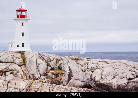 Peggy's Point Lighthouse on a stormy day in May at Peggy's Cove near Halifax, Nova Scotia, Canada. Stock Photo