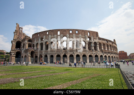 Roman Colosseum in Rome, Italy with tourists, visitors, walking around the outside. Stock Photo