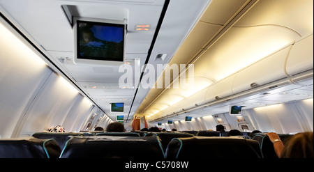 June 2011, inside of a passenger airline, backs of passengers, somewhere over Asia Indian Ocean Stock Photo