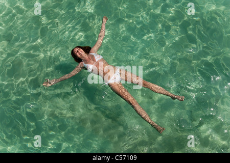 Woman floating in tropical sea Stock Photo