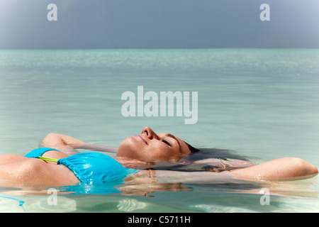 Woman floating in tropical sea Stock Photo