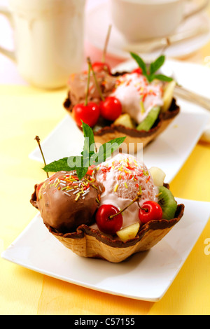 Tulip wafers with ice cream and fruit salad. Recipe available. Stock Photo