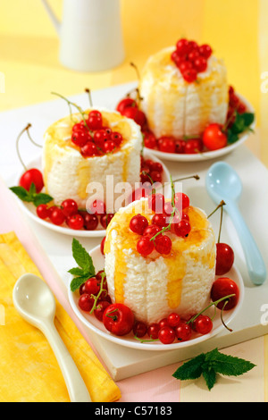 Soft cheese with honey, cherries and red currants. Recipe available. Stock Photo