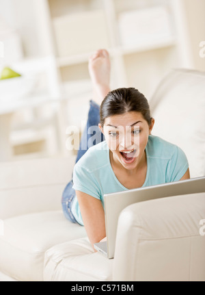 Surprised woman using laptop Stock Photo