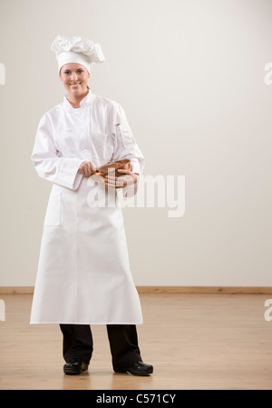 Smiling chef holding mixing bowl Stock Photo