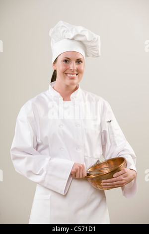 Smiling chef holding mixing bowl Stock Photo