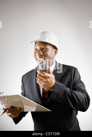 Businessman using walkie talkie Stock Photo