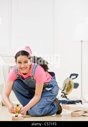 Woman using power tools at home Stock Photo