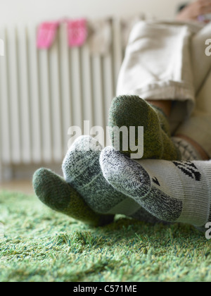 Close up of couple’s feet in socks Stock Photo