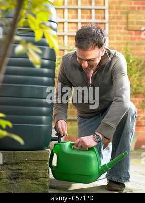 Man filling jug with recycled water Stock Photo