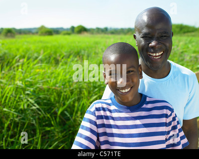 Father and son in field together Stock Photo